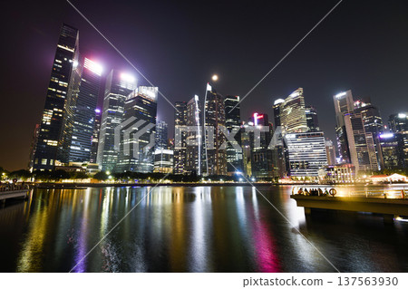 Night view of modern skyscrapers along Marina Bay in the Raffles Place financial district from the Marina Bay Sands observation deck, Singapore. Night view of modern skyscrapers along Marina Bay in the Raffles Place financial district from the Marina Bay Sands observation deck, Singapore. 137563930