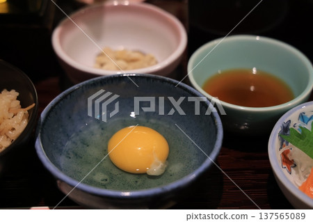 Nov 25 2025 Soft Egg Yolk In Blue Ceramic Bowl With Rice, Tea, 137565089