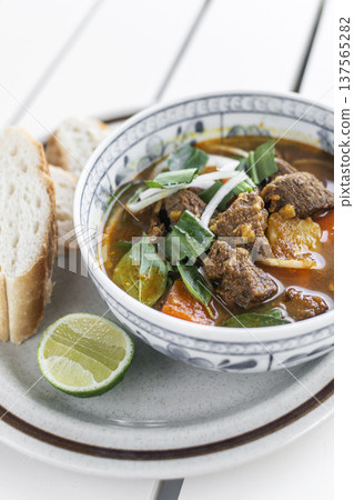 Bo Kho traditional vietnamese beef and vegetable stew on white table in da nang vietnam restaurant Bo Kho traditional vietnamese beef and vegetable stew on white table in da nang vietnam restaurant 137565282
