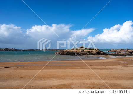 Rocky tidal island under bright skies in Tregastel, Brittany, France Rocky tidal island under bright skies in Tregastel, Brittany, France 137565313