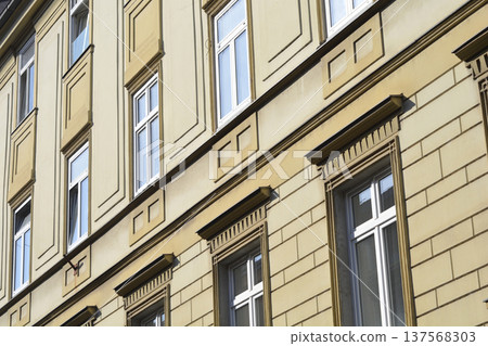 Historical building facade with multiple windows and architectural details Historical building facade with multiple windows and architectural details 137568303