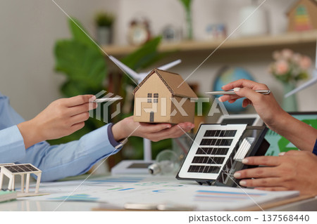 Sustainability in Action: Discussing Eco-Friendly Solutions with Model House and Solar Panel Sustainability in Action: Discussing Eco-Friendly Solutions with Model House and Solar Panel 137568440