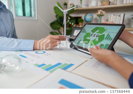ESG Strategy Discussion: Professionals Analyzing Data on Sustainability and Governance 137568449