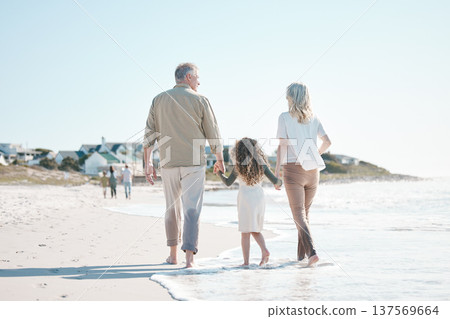 Relax, holding hands and grandparents with child at beach for travel, love and support. Summer vacation, care and retirement with family walking on seaside holiday for adventure, bonding and peace Relax, holding hands and grandparents with child at beach for travel, love and support. Summer vacation, care and retirement with family walking on seaside holiday for adventure, bonding and peace 137569664