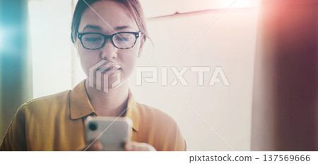 Phone, serious and business woman typing in office, social media and networking in creative startup. Smartphone, scroll and professional designer online, reading email notification and communication Phone, serious and business woman typing in office, social media and networking in creative startup. Smartphone, scroll and professional designer online, reading email notification and communication 137569666