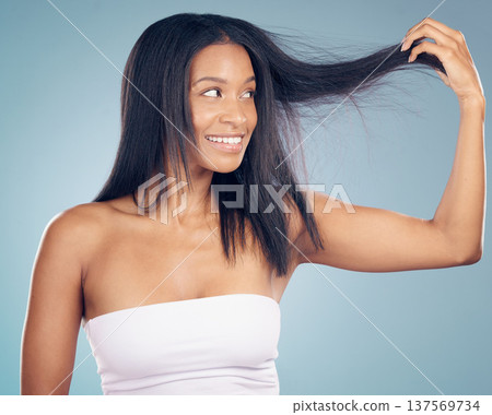 Hair care, texture and happy woman with split ends in studio or blue background for salon keratin treatment. Beauty, growth or female model smiling with hairstyle damage, collagen or cosmetic problem Hair care, texture and happy woman with split ends in studio or blue background for salon keratin treatment. Beauty, growth or female model smiling with hairstyle damage, collagen or cosmetic problem 137569734