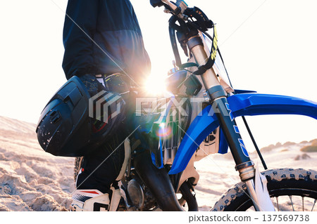 Motorcycle, helmet and man at desert for adventure, travel and lens flare. Motorbike, hand and closeup of rider in nature for freedom, sports training and driving on sand, dirt and off road journey Motorcycle, helmet and man at desert for adventure, travel and lens flare. Motorbike, hand and closeup of rider in nature for freedom, sports training and driving on sand, dirt and off road journey 137569738