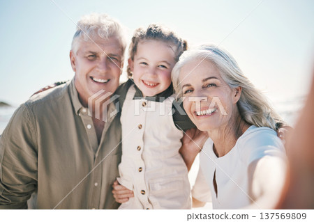 Family, selfie and beach holiday with grandparents and young girl together with a smile. Happy, child and portrait at the sea and ocean with a profile picture pov for social media on summer vacation 137569809