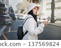 Woman on street with phone, taxi app and travel holiday with streetwear, waiting and online location. Influencer, blogger or gen z girl with urban fashion, smartphone and cab transport in city road 137569824