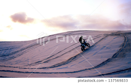 Sand, desert or athlete with motorcycle for action, adventure or fitness with performance for adrenaline. Sunset, sports or person on motorbike on dunes for training, exercise or race or challenge Sand, desert or athlete with motorcycle for action, adventure or fitness with performance for adrenaline. Sunset, sports or person on motorbike on dunes for training, exercise or race or challenge 137569833