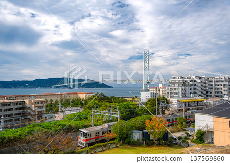 A view of the Sanyo Electric Railway running along the coast with the Akashi Kaikyo Bridge and Awaji Island in the background in Kobe, Hyogo Prefecture A view of the Sanyo Electric Railway running along the coast with the Akashi Kaikyo Bridge and Awaji Island in the background in Kobe, Hyogo Prefecture 137569860