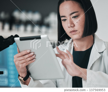 Scientist, woman and tablet of laboratory research, data analysis and reading results or online vaccine report. Asian doctor or medical expert on digital technology for science software in healthcare Scientist, woman and tablet of laboratory research, data analysis and reading results or online vaccine report. Asian doctor or medical expert on digital technology for science software in healthcare 137569953