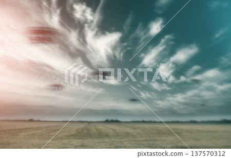 UFO, spaceship and nature with alien in sky with fantasy or science fiction event in countryside, field or landscape with clouds. Earth, aliens and extraterrestrial drone in environment with blur 137570312