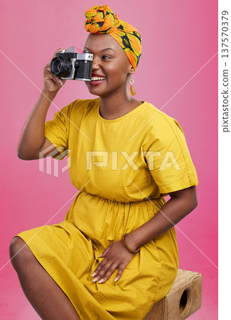 Camera, studio and happy black woman shooting photo, picture or photography of creative fashion design. Creativity photoshoot, talent artist and African production photographer on pink background 137570379
