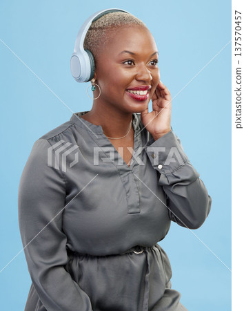 Headphones, music and black woman on blue background with smile for happiness, relax and chill. Internet, technology and happy African person streaming audio, listening to radio and song in studio 137570457
