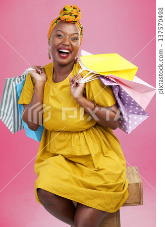 Shopping bag, studio portrait and black woman excited for discount promotion, fashion spree choice or commerce deal. Market product, package or African customer with retail present on pink background 137570498