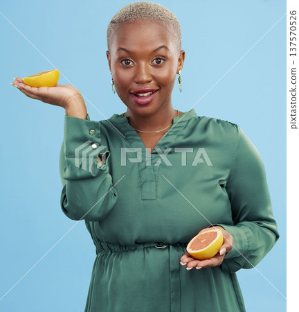 Black woman, portrait and orange for vitamin C in diet, natural nutrition or detox against a studio background. Happy African female person smile with healthy organic citrus fruit for body wellness 137570526