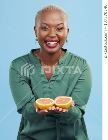 Happy black woman, portrait and orange for vitamin C in diet, natural nutrition or detox against a studio background. African female person smile with healthy organic citrus fruit for body wellness 137570546