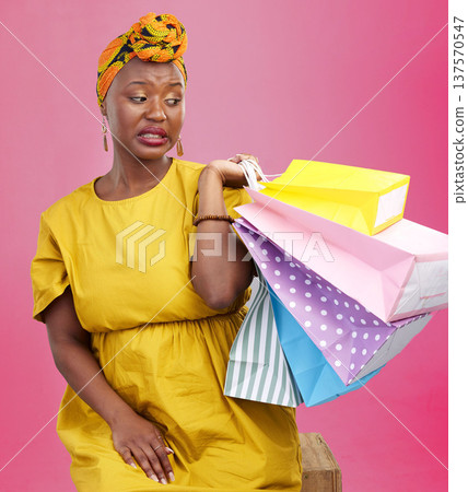 Studio bag, shopping problem or black woman with bad shop product, boutique crisis or shopaholic. Facial expression, mistake or African customer disappointed with retail present on pink background Studio bag, shopping problem or black woman with bad shop product, boutique crisis or shopaholic. Facial expression, mistake or African customer disappointed with retail present on pink background 137570547