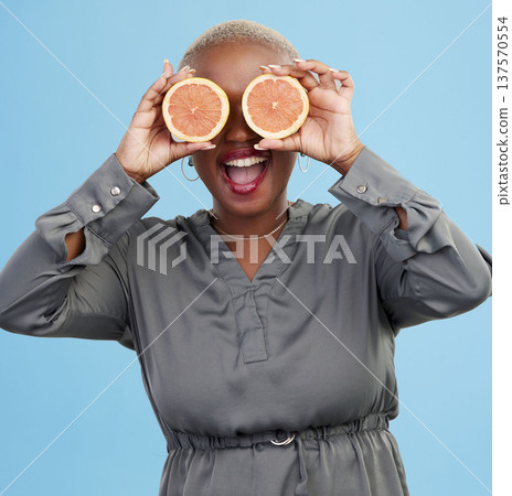 Happy black woman, orange and vitamin C in diet, natural nutrition or detox against a studio background. Portrait of African female person smile with healthy organic citrus fruit for body wellness Happy black woman, orange and vitamin C in diet, natural nutrition or detox against a studio background. Portrait of African female person smile with healthy organic citrus fruit for body wellness 137570554