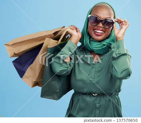Studio bag, shopping and black woman excited for holiday fashion spree, commerce discount or boutique giveaway deal. Financial freedom, luxury product and wealthy African customer on blue background Studio bag, shopping and black woman excited for holiday fashion spree, commerce discount or boutique giveaway deal. Financial freedom, luxury product and wealthy African customer on blue background 137570650
