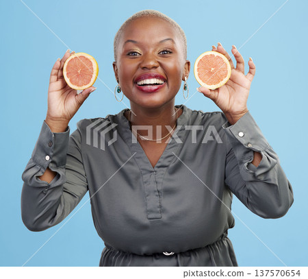 Happy black woman, portrait and orange for vitamin C, natural nutrition or diet against a studio background. Portrait of African female person smile with healthy organic citrus fruit in body wellness Happy black woman, portrait and orange for vitamin C, natural nutrition or diet against a studio background. Portrait of African female person smile with healthy organic citrus fruit in body wellness 137570654