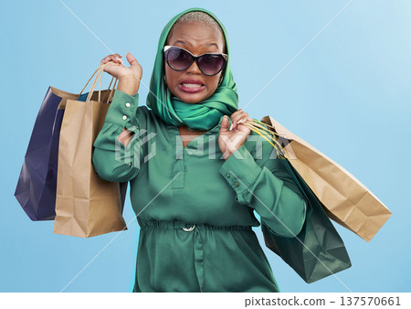 Black woman, portrait and shopping bags in fashion, style or sunglasses against a studio background. African female person shopper with scarf, gifts or groceries in clothing mistake, fail or sale Black woman, portrait and shopping bags in fashion, style or sunglasses against a studio background. African female person shopper with scarf, gifts or groceries in clothing mistake, fail or sale 137570661