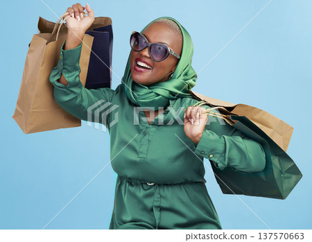 Shopping bag, studio smile and black woman excited for luxury fashion spree, mall store sales or commerce deal. Retail therapy package, market gift choice and rich African customer on blue background Shopping bag, studio smile and black woman excited for luxury fashion spree, mall store sales or commerce deal. Retail therapy package, market gift choice and rich African customer on blue background 137570663