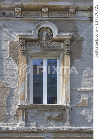 Historic Window with Decorative Female Face Relief Historic Window with Decorative Female Face Relief 137570725