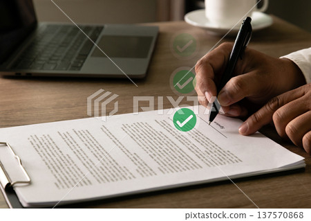 Completed contract signature and approval confirmation with verification and compliance workflow in professional business office setting. 137570868