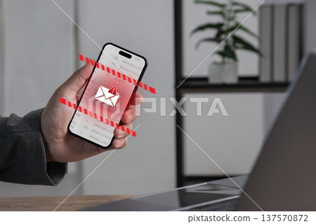 Smartphone displaying email security alert with warning phishing detection interface. cyber attack prevention, spam filtering, data protection and junk and trash mail communication technology. Smartphone displaying email security alert with warning phishing detection interface. cyber attack prevention, spam filtering, data protection and junk and trash mail communication technology. 137570872