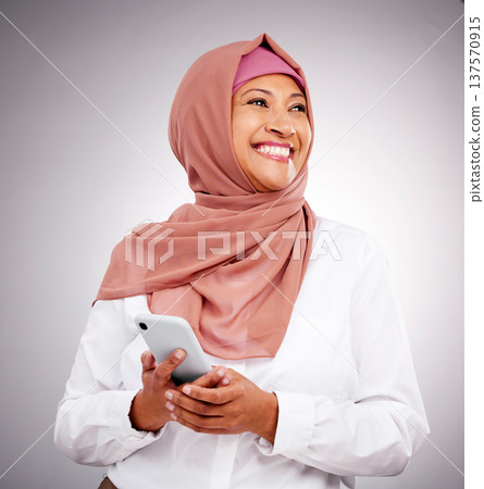 Muslim, phone and business woman with thinking and smile for career and vision with islamic company. Smartphone, person and employee in hijab or leader with corporate motivation and mindset in studio Muslim, phone and business woman with thinking and smile for career and vision with islamic company. Smartphone, person and employee in hijab or leader with corporate motivation and mindset in studio 137570915