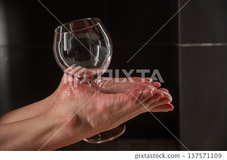 Foot fetish. A woman holds a wine glass in the shower. 137571109