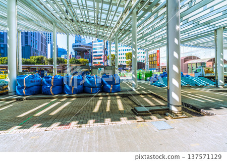 Yokohama cityscape, Japan, March 11. Work is underway to repair the damaged sidewalk at the west exit of Yokohama Station. Materials, heavy machinery, and waste are lined up. 137571129