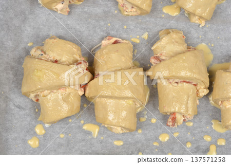 Raw rolls with roasted peppers on baking paper Raw rolls with roasted peppers on baking paper 137571258