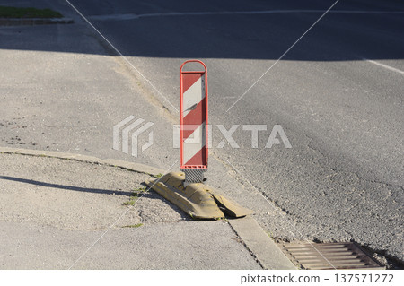 Red-White Traffic Delineator on Damaged Base Red-White Traffic Delineator on Damaged Base 137571272