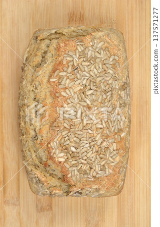 Homemade whole grain bread with sunflower seeds on wooden background 137571277