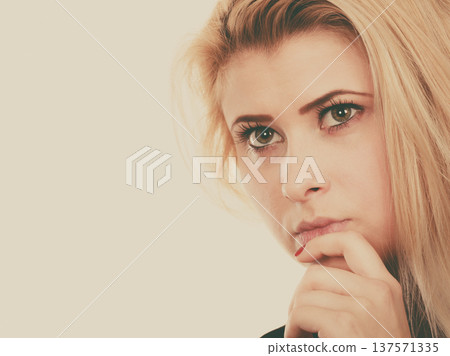 Attractive blonde woman thinking and contemplating Attractive blonde woman thinking and contemplating 137571335