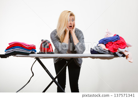 Woman having enough of ironing clothes 137571341