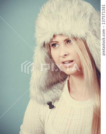Blonde woman in winter furry hat 137571381