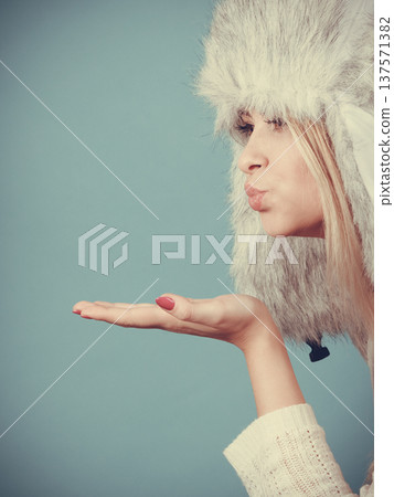 Blonde woman in winter warm furry hat Blonde woman in winter warm furry hat 137571382