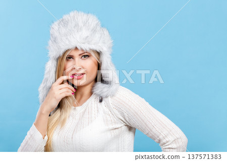 Woman wearing winter furry warm hat 137571383