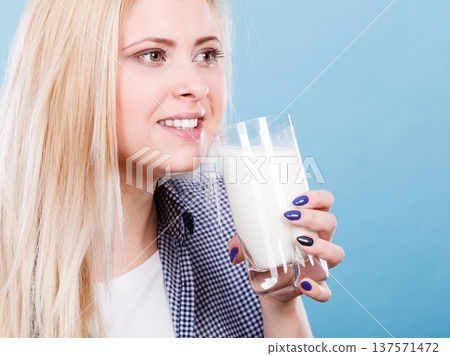 Woman drinking milk from glass Woman drinking milk from glass 137571472