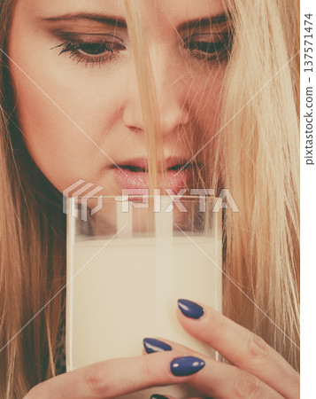Woman drinking milk from glass 137571474