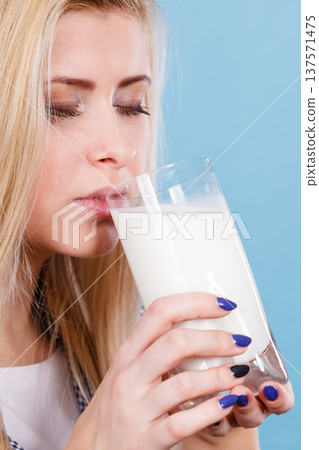 Woman drinking milk from glass 137571475