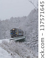 Koumi Line Kiha 200 series train crossing the railway bridge at the prefectural border in the snow 137571645