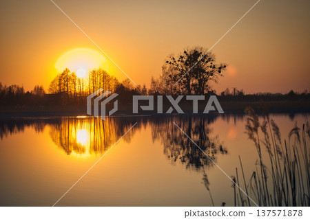 Sunset over the lake on a spring day Sunset over the lake on a spring day 137571878