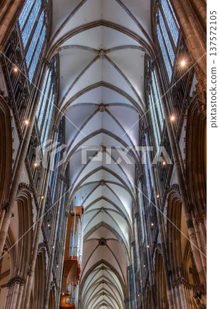Interior view of Cologne Cathedral in Germany. Tall stone columns, intricate arches, and colorful stained glass windows create a majestic atmosphere. Interior view of Cologne Cathedral in Germany. Tall stone columns, intricate arches, and colorful stained glass windows create a majestic atmosphere. 137572105