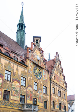 Historic Ulm Rathaus building in Germany features intricate frescoes and a tall spire. The architecture showcases traditional German design elements. 137572113