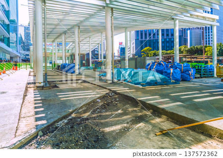 Yokohama cityscape, Japan, March 11. Work is underway to repair the damaged sidewalk at the west exit of Yokohama Station. Materials, heavy machinery, and waste are lined up. 137572362
